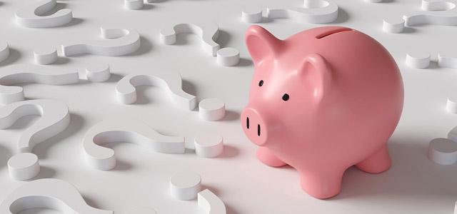 A piggy bank surrounded by question marks